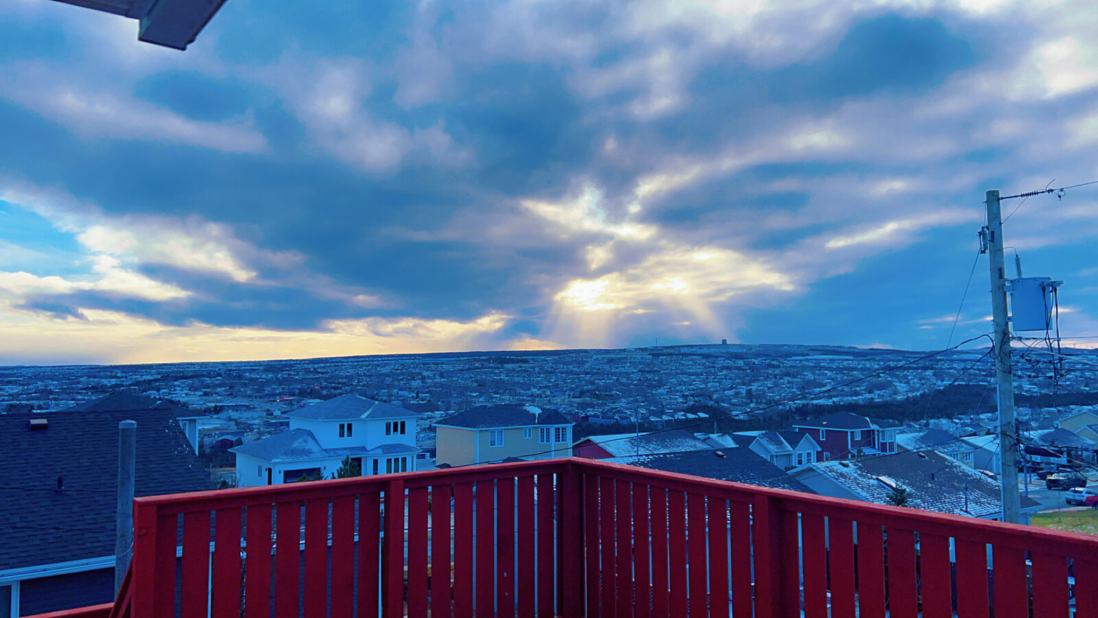 View of snow-covered rooftops from the shared deck in winter